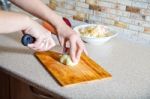 Woman Cuts Onion Stock Photo