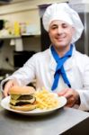 Male Chef Serving The Order Stock Photo