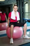 Pretty Fit Woman Sitting On Pink Swiss Ball Stock Photo