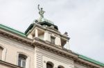 Statue Of A Woman On Top Of A House In Vienna Stock Photo