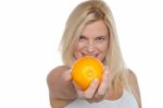 Gorgeous Woman With An Orange In Her Outstretch Arm Stock Photo