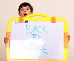 Little Boy Holding A Whitebaord Stock Photo