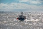 Fishing Boat Racing Home To Lyme Regis Harbour Stock Photo