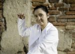 Woman Playing A Bell, Traditionally Used To Aid Meditation In Bu Stock Photo