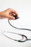 Hand On Stethoscope On White Background Stock Photo