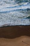 Couple Walking On The Shore Stock Photo