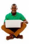 Sitting African Guy Using Laptop Stock Photo