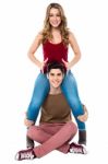 Gorgeous Girl Sitting On Her Boyfriend's Shoulder Stock Photo