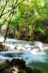 The Water Flowing Over Rocks And Trees Down A Waterfall At Huay Mae Khamin Waterfall National Park ,kanchana Buri In Thailand Stock Photo