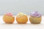 3 Color Choux Or Profiterole Or Eclair On Wood Table Straight Line View Stock Photo