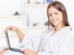 Girl In Bathrobe With Computer Stock Photo