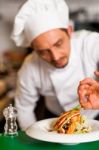 Professional Chef Preparing Baked Salmon To Be Served Stock Photo