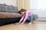 Young Woman Washing Wooden Floor With Blue Floorcloth Stock Photo