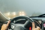 View Through The Cars Windshield  In The Winter Fog On The Road Stock Photo