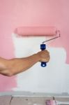 Hand Painting Wall With Paint Roller Stock Photo