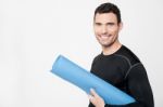 Gym Instructor Holding Mat Stock Photo