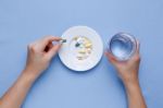 Taking Pill With Pills On Plate Stock Photo