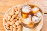 Glass Of Black Iced Coffee With Almond Grain Stock Photo