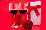 St Valentine's Setting With Present And Red Wine Stock Photo