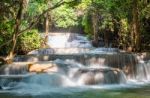 The Water Flowing Over Rocks And Trees Down A Waterfall At Huay Mae Khamin Waterfall National Park ,kanchana Buri In Thailand Stock Photo