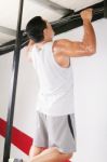 Man Performing Pull Ups In A Bar Stock Photo