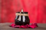 Black Candle Cup On Red Background Stock Photo