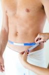 Man With A Helthy Body Measuring His Stomach. Diet Concept Stock Photo