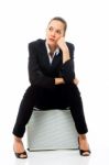 Woman Sitting On Briefcase Stock Photo