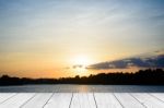 Wood Table Top On Blur Sunrise Background/ Use For Montage On Product Display Stock Photo