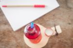 Red Syrup In The Bottle On Wooden Plate Stock Photo