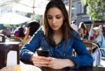 Beautiful Young Woman Using Her Mobile Phone In The Street Stock Photo