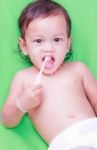 Asian Baby And Toothbrush Stock Photo