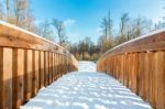 Snow On Wooden Bridge In Forest Stock Photo