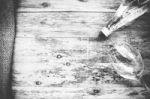 Water Bottle And Glass On The Wooden Table, Black & White Stock Photo