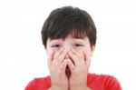 Boy With His Hands Over His Mouth Stock Photo