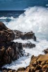 Waves Pounding The Coastline At Capo Testa Stock Photo