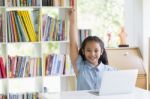 Happy Little Asian Girl Celebrate With Laptop Stock Photo