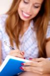 Woman Writing In Notepad Stock Photo