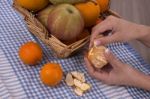 Woman Hands Peeling A Mandarin Stock Photo