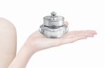 Silver Deluxe Cosmetic Jar On Hand Isolated Stock Photo