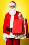 Joyous Santa Posing With Colorful Shopping Bags Stock Photo