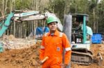 Excavator And Workers Stock Photo