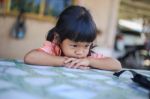 Sad Little Girl Holding Her Face Stock Photo