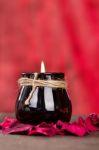 Black Candle Cup On Red Background Stock Photo