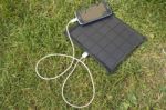 Mobile Phone Charging With Solar Energy - Charger Stock Photo