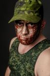 Military Style Camouflage On The Soldier's Face Stock Photo