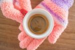 Gloved Hands Holding Cup Of Coffee Stock Photo