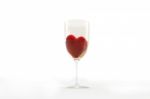 Red Heart Dug In Wine Glass Stock Photo