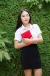 Thai Adult Student University Beautiful Girl Reading Red Book Stock Photo