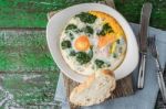 Florentine Eggs With Pureed Spinach On The Wooden Table Horizontal Stock Photo